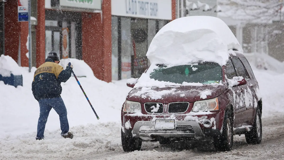 A vehicle drives with snow on the roof during a snowstorm as extreme winter weather hits Buffalo, New York, U.S., November 18, 2022.  REUTERS/Lindsay DeDario
