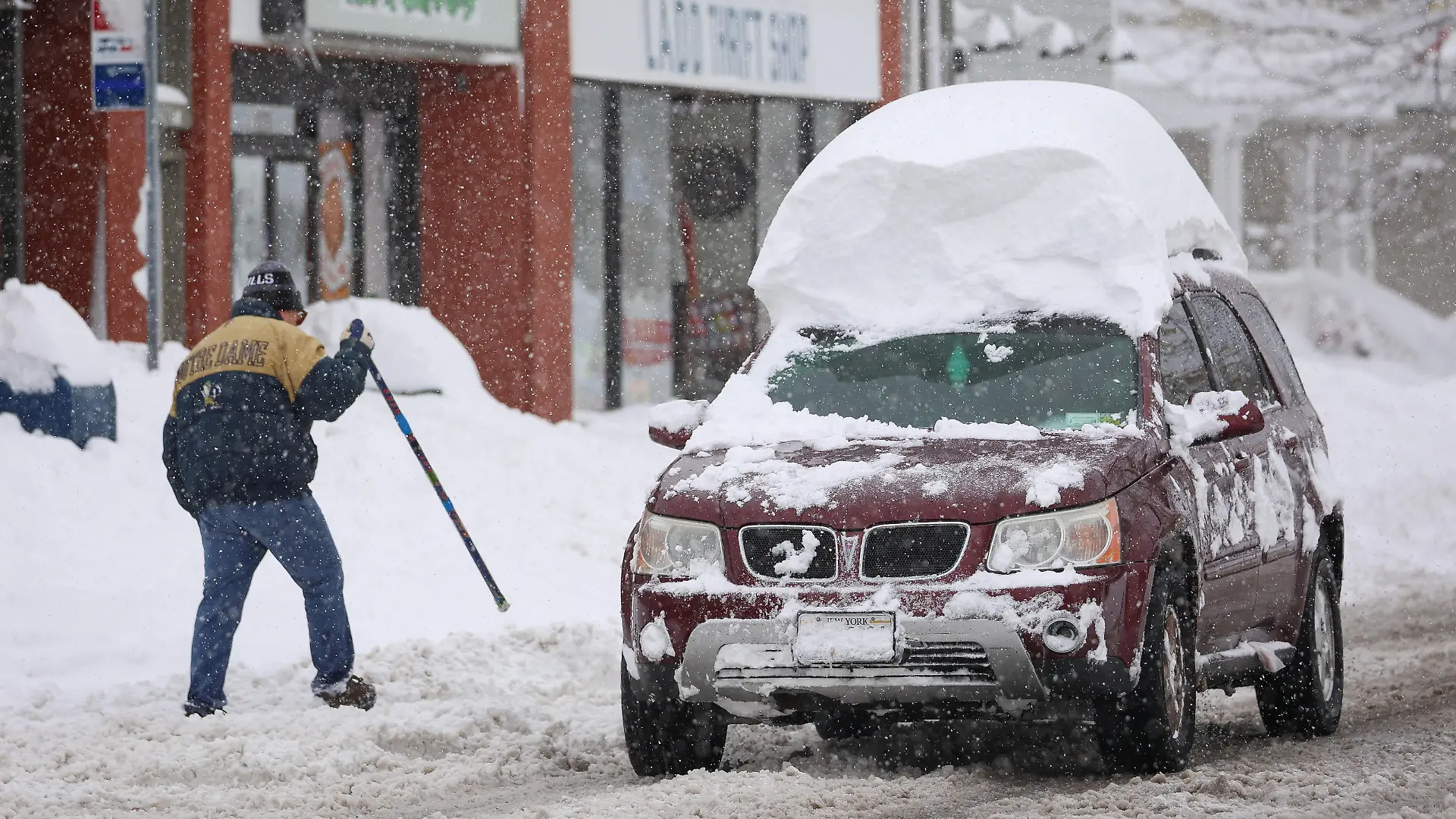 A vehicle drives with snow on the roof during a snowstorm as extreme winter weather hits Buffalo, New York, U.S., November 18, 2022. REUTERS/Lindsay DeDario