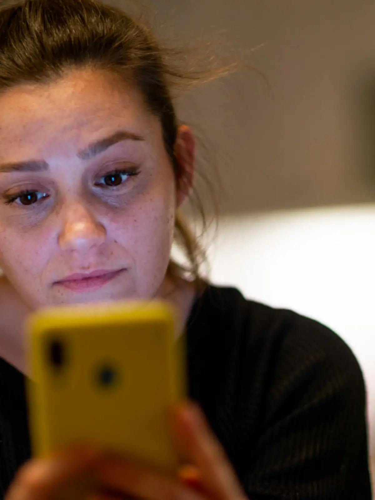 Young woman looking at smartphone confused by received sms or notification, bad news reading on cell phone feels upset, negative response concept.