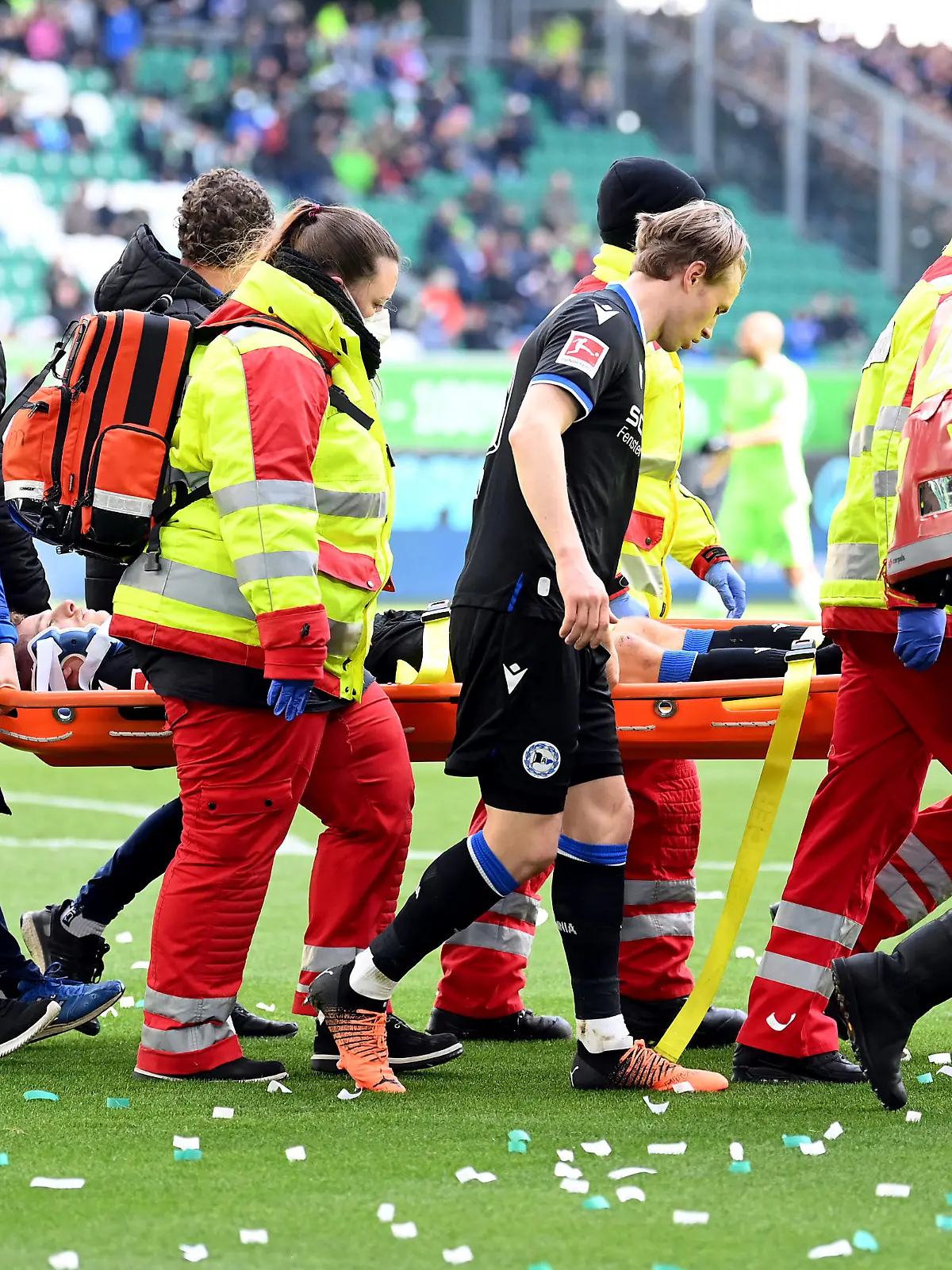 WOLFSBURG, GERMANY - APRIL 09: Cedric Brunner of DSC Arminia Bielefeld is stretchered off after an injury during the Bundesliga match between VfL Wolfsburg and DSC Arminia Bielefeld at Volkswagen Arena on April 09, 2022 in Wolfsburg, Germany. (Photo by Stuart Franklin/Getty Images)