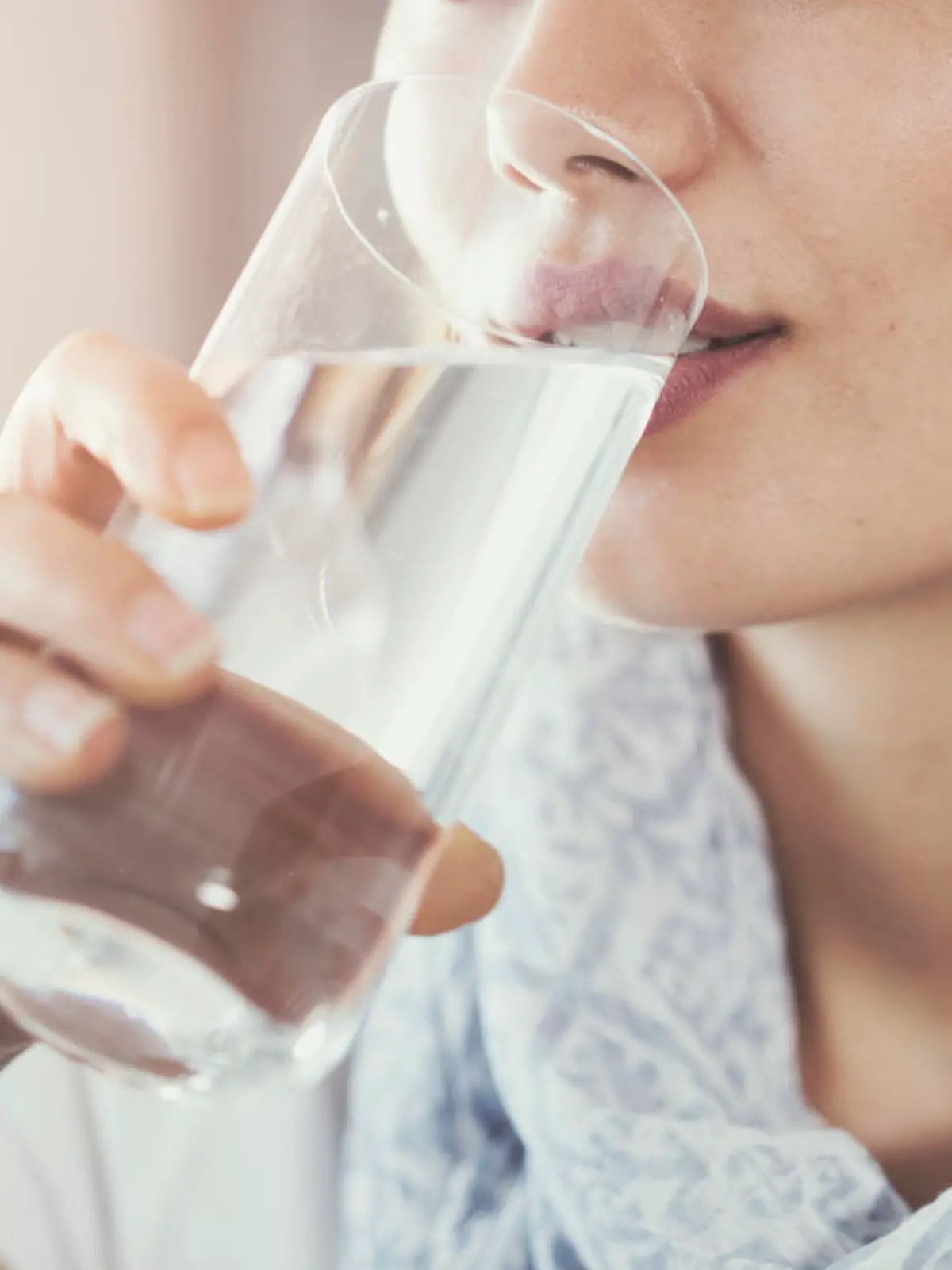 Young woman drinking pure glass of water
