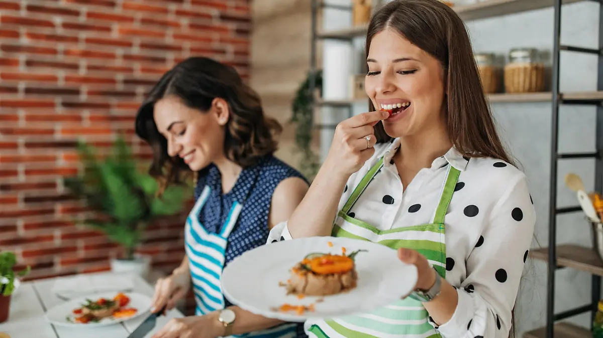 Young women preparing food in the kitchen