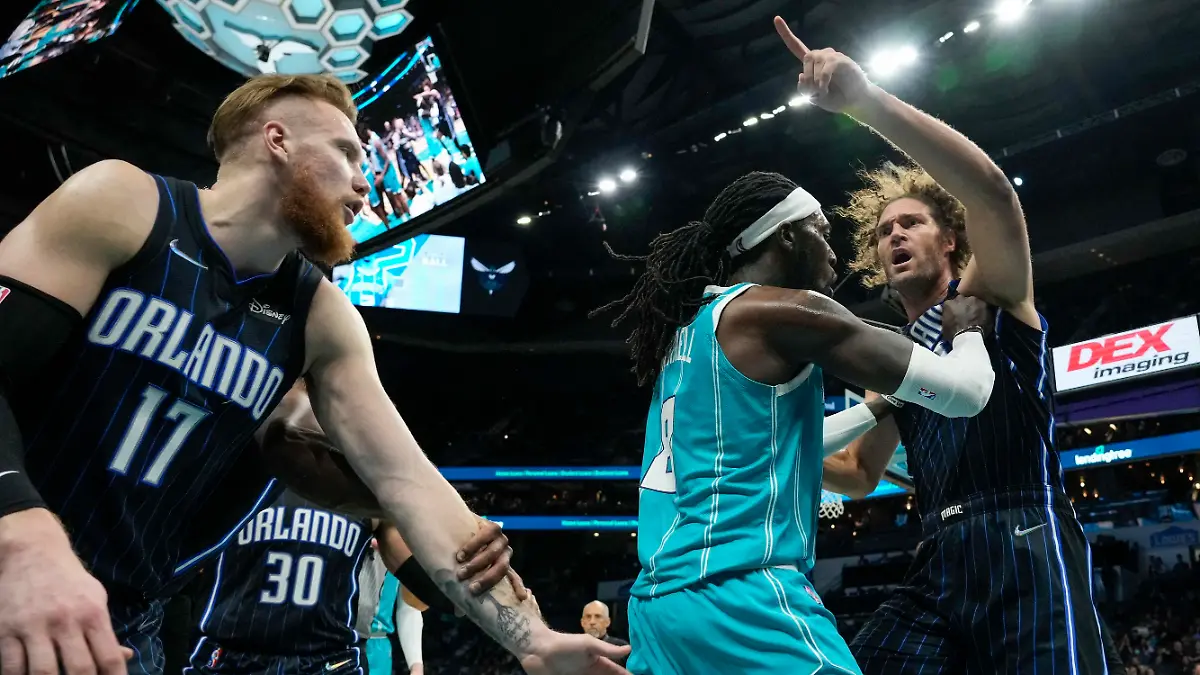 Apr 7, 2022; Charlotte, North Carolina, USA; Charlotte Hornets center Montrezl Harrell (8) tries to clear Orlando Magic center Robin Lopez (right) from an altercation that would later see both players ejected, as well as Magic forward Admiral Schofield (not pictured) during the second half at Spectrum Center. Mandatory Credit: Jim Dedmon-USA TODAY Sports