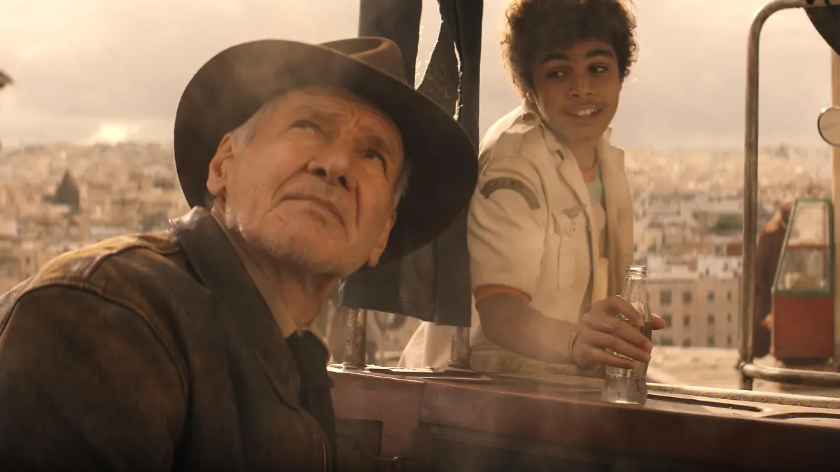 (L-R): Indiana Jones (Harrison Ford) and Teddy (Ethann Isidore) in Lucasfilm's INDIANA JONES AND THE DIAL OF DESTINY. ©2023 Lucasfilm Ltd. & TM. All Rights Reserved.