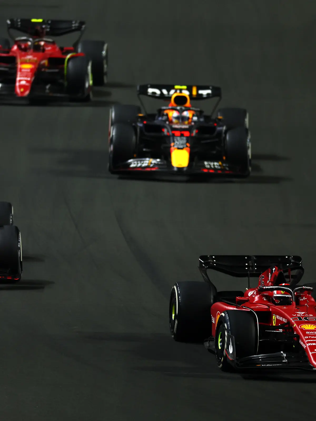 JEDDAH, SAUDI ARABIA - MARCH 27: Charles Leclerc of Monaco driving (16) the Ferrari F1-75 leads Max Verstappen of the Netherlands driving the (1) Oracle Red Bull Racing RB18, Sergio Perez of Mexico driving the (11) Oracle Red Bull Racing RB18 and Carlos Sainz of Spain driving (55) the Ferrari F1-75 on track during the F1 Grand Prix of Saudi Arabia at the Jeddah Corniche Circuit on March 27, 2022 in Jeddah, Saudi Arabia. (Photo by Lars Baron/Getty Images)