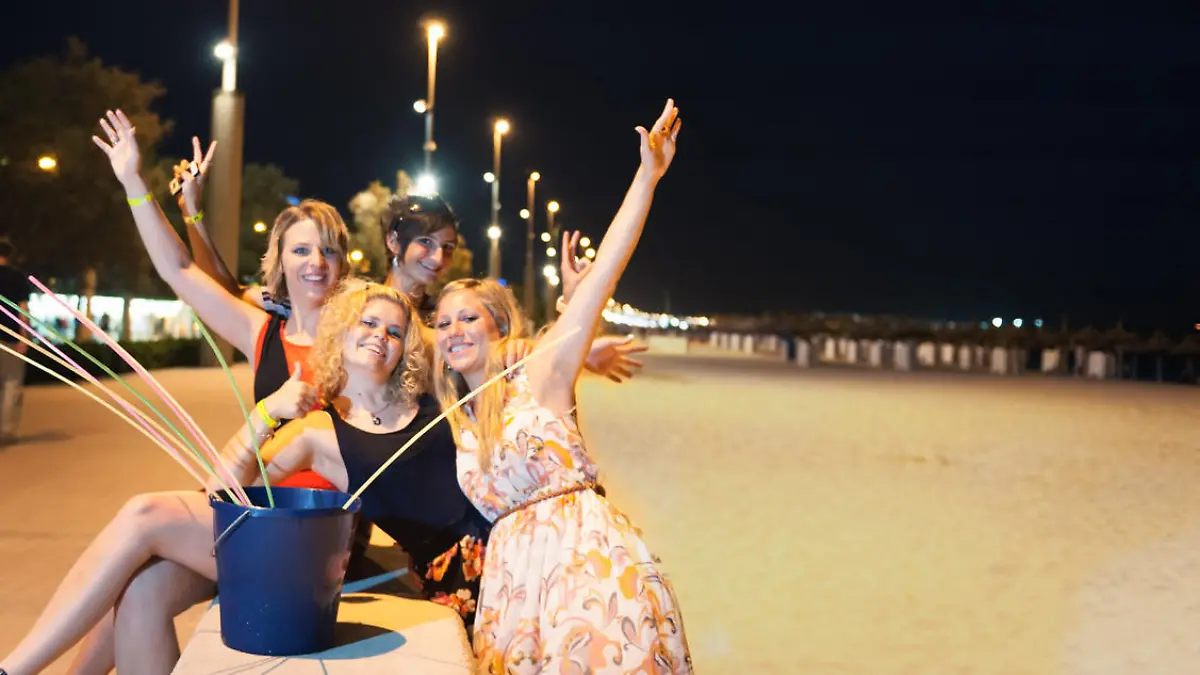 Girls having fun at evening at the beach of majora called ,,Ballermann" with the typical drink, little motion blur, flash to fill in the shadows, long time exposure to keep the ambient light, downscaled for better quality, Nikon D700