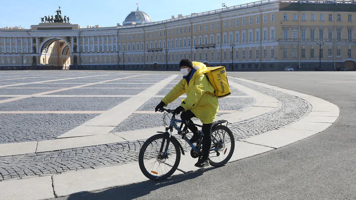 Employee of Yandex delivers foods on an empty Palace square in the center of St. Petersburg, Russia, on April 7, 2020. Russian President Vladimir Putin signed a decree on days off until April 30. Citizens are asked to observe a self-isolation regime in order to prevent the spread of the coronavirus (covid-19). (Photo by Valya Egorshin/NurPhoto)