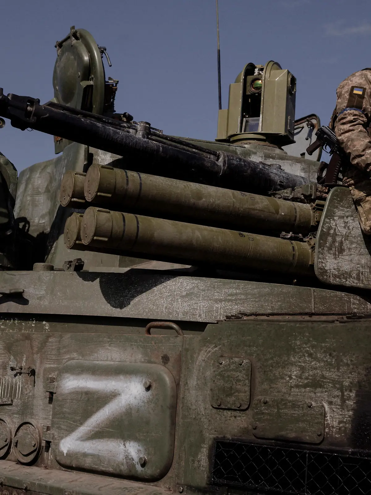 FILE PHOTO: A Ukrainian soldier sits on top of a Russian artillery vehicle marked with the 'Z' symbol, which Ukraine captured during fighting outside Kharkiv, as Russia's attack on Ukraine continues, Ukraine, March 29, 2022.  REUTERS/Thomas Peter/File Photo