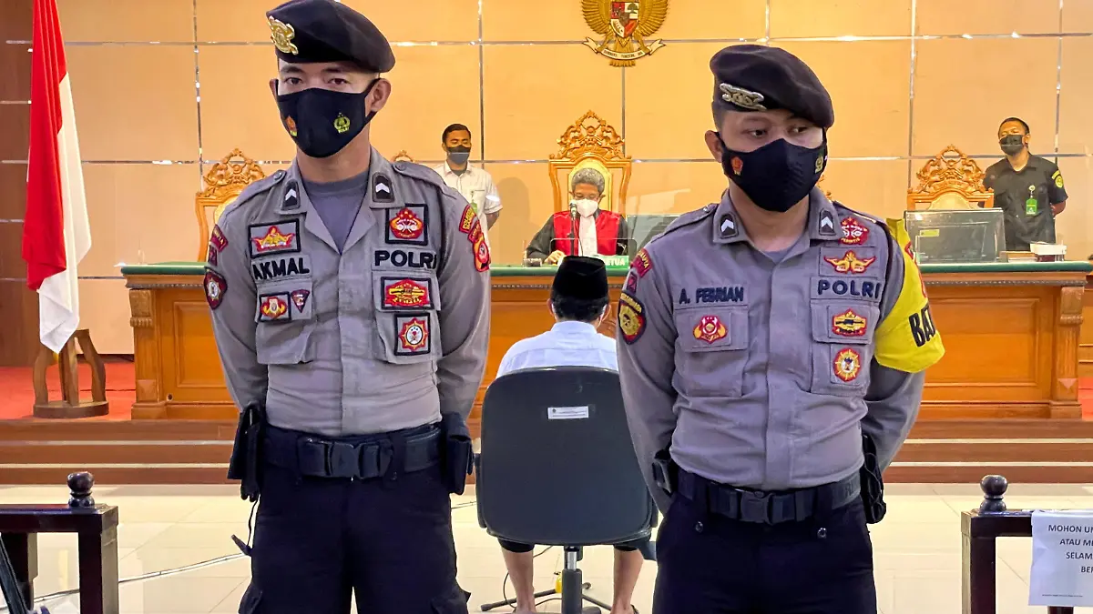 FILE PHOTO: Police officers stand guard during the verdict trial against Herry Wirawan (36), a former teacher and founder of an Islamic boarding school, who is accused of raping 13 school girls between 2016 and 2021, at the district court in Bandung, West Java province, Indonesia February 15, 2022. REUTERS/Heru Asprihanto/File Photo