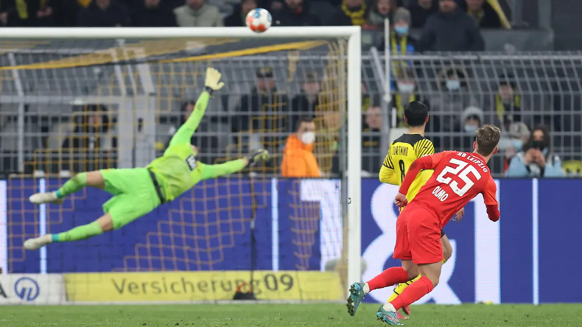 DORTMUND, GERMANY - APRIL 02: Dani Olmo of RB Leipzig scores their side's fourth goal past Gregor Kobel of Borussia Dortmund during the Bundesliga match between Borussia Dortmund and RB Leipzig at Signal Iduna Park on April 02, 2022 in Dortmund, Germany. (Photo by Alex Grimm/Getty Images)
