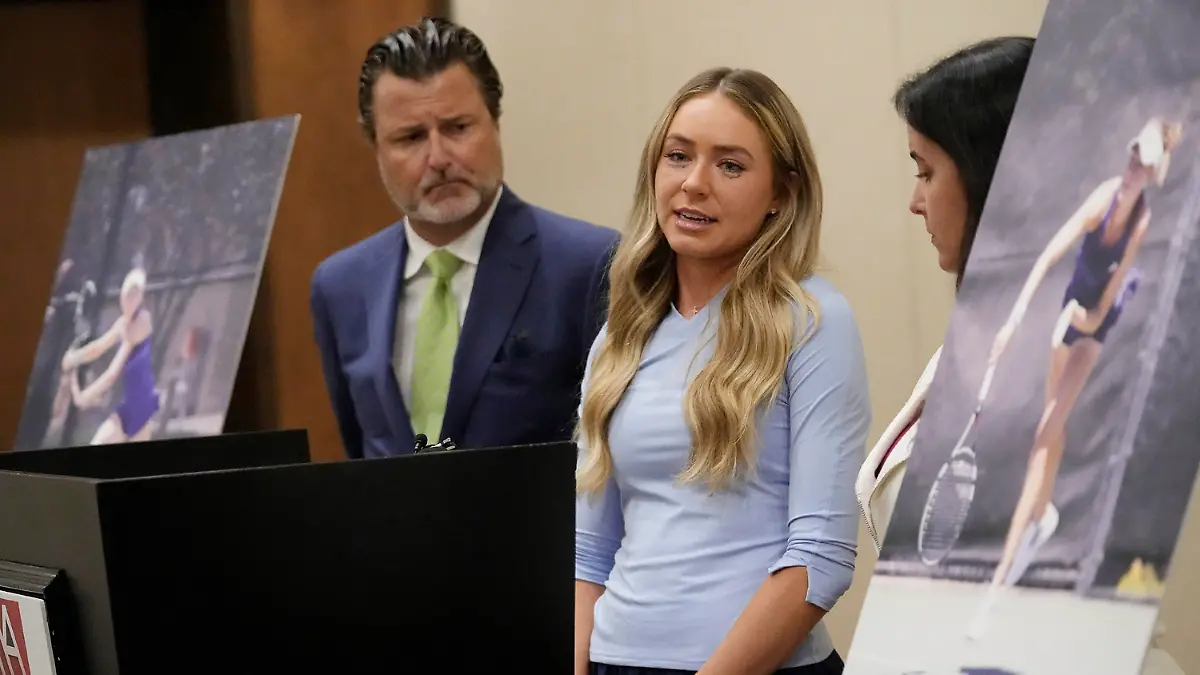Tennis player Kylie McKenzie, middle, with her attorney Robert Allard, left, and victim advocate Jancy Thompson, speaks to reporters at a news conference in Phoenix Tuesday, March 29, 2022. McKenzie alleges in a lawsuit that the U.S. Tennis Association failed to protect her from a coach who she says sexually abused her when she was 19. The Associated Press generally doesn't name alleged sexual assault victims but McKenzie agreed to let her identity be known in coverage of her lawsuit. (Michael Chow/The Arizona Republic via AP)