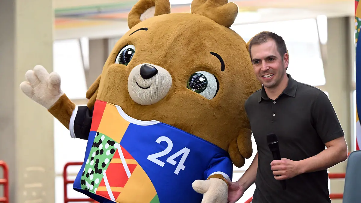 20.06.2023, Nordrhein-Westfalen, Gelsenkirchen: Fußball: EM 2024, Vorstellung des offiziellen Maskottchens. Das noch namenlose Maskottchen steht mit Turnierdirektor Philipp Lahm auf der Bühne. Ein kleiner Bär - mit Hose. Die Europäische Fußball-Union UEFA hat am Dienstag (20.06.2023) das Maskottchen für die EM 2024 in Deutschland vorgestellt. Über den Namen des 2024er-Maskottchens können in den kommenden zwei Wochen Kinder aus dem UEFA-Schulfußballprogramm sowie alle Fans abstimmen. Zur Auswahl stehen: Albärt, Bärnardo, Bärnheart und Herzi von Bär. Foto: Federico Gambarini/dpa +++ dpa-Bildfunk +++