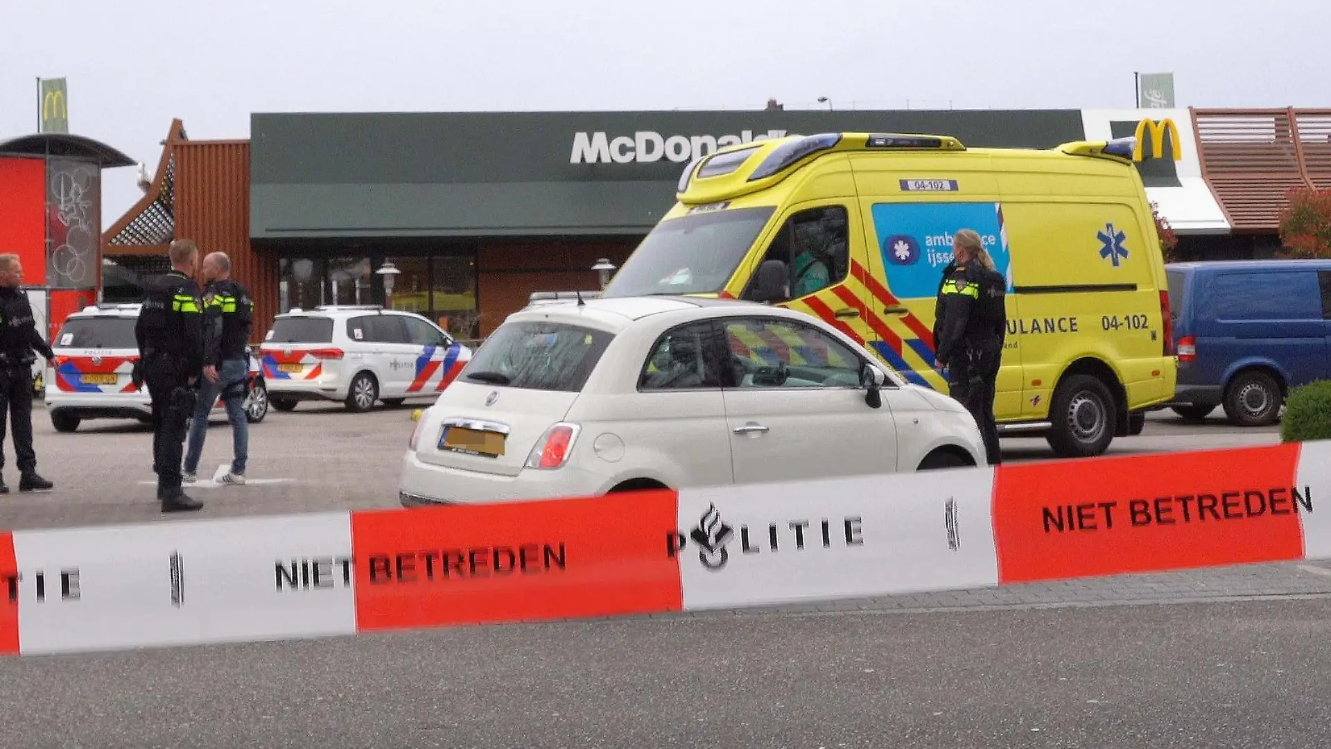 Police officers stand guard in front of a McDonald's restaurant, after two people were killed when a gunman opened fire at a McDonald's restaurant as reported by police and Dutch media, in Zwolle, north of Netherlands, on March 30, 2022. - Netherlands OUT (Photo by STRINGER / ANP / AFP) / Netherlands OUT (Photo by STRINGER/ANP/AFP via Getty Images)