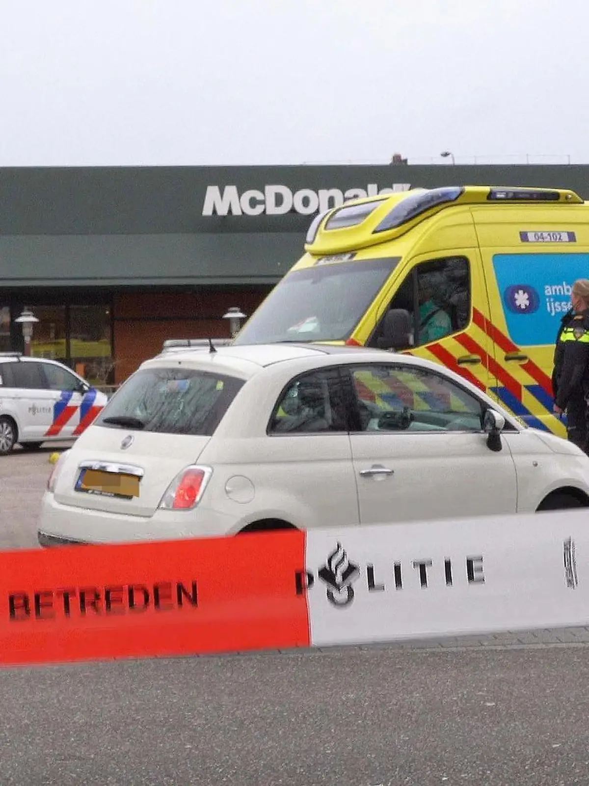 Police officers stand guard in front of a McDonald's restaurant, after two people were killed when a gunman opened fire at a McDonald's restaurant as reported by police and Dutch media, in Zwolle, north of Netherlands, on March 30, 2022. - Netherlands OUT (Photo by STRINGER / ANP / AFP) / Netherlands OUT (Photo by STRINGER/ANP/AFP via Getty Images)