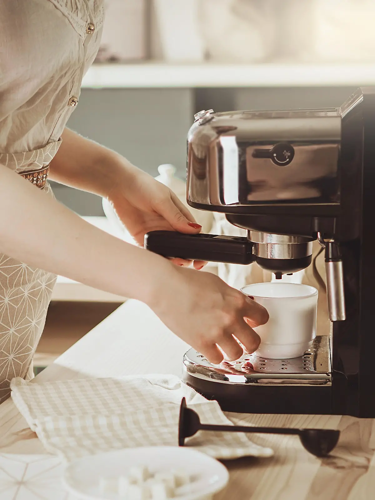 Woman making fresh espresso in coffee maker. coffee machine makes coffee. Barista Coffee Maker Machine Grinder Portafilter Concept