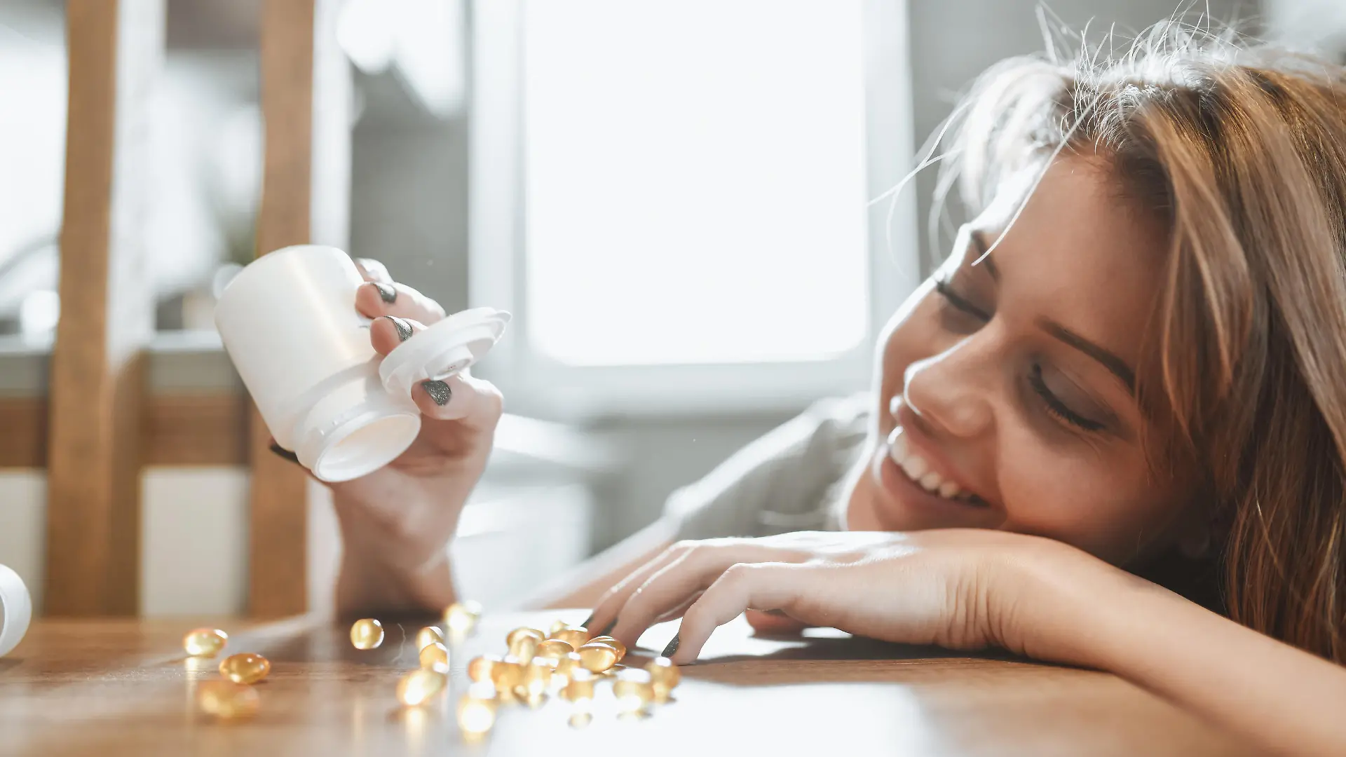 Cute Female Counting Her Vitamins In Kitchen