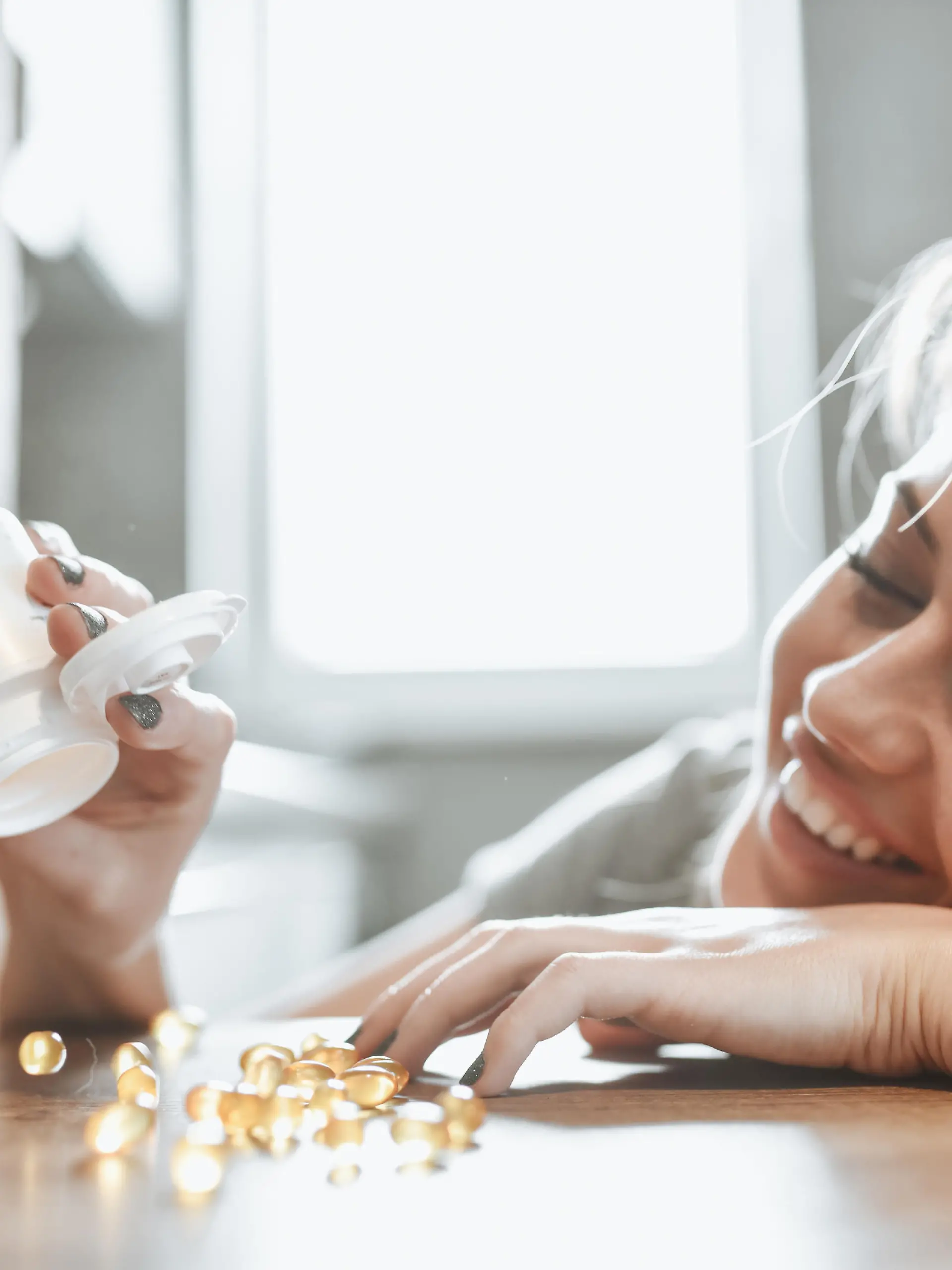Cute Female Counting Her Vitamins In Kitchen