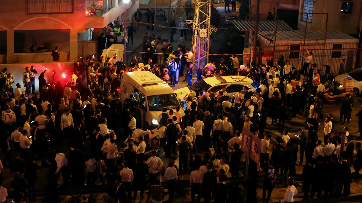 People gather at the scene of an attack in which people were killed by a gunman on a main street in Bnei Brak, near Tel Aviv, Israel, March 29, 2022. REUTERS/Nir Elias