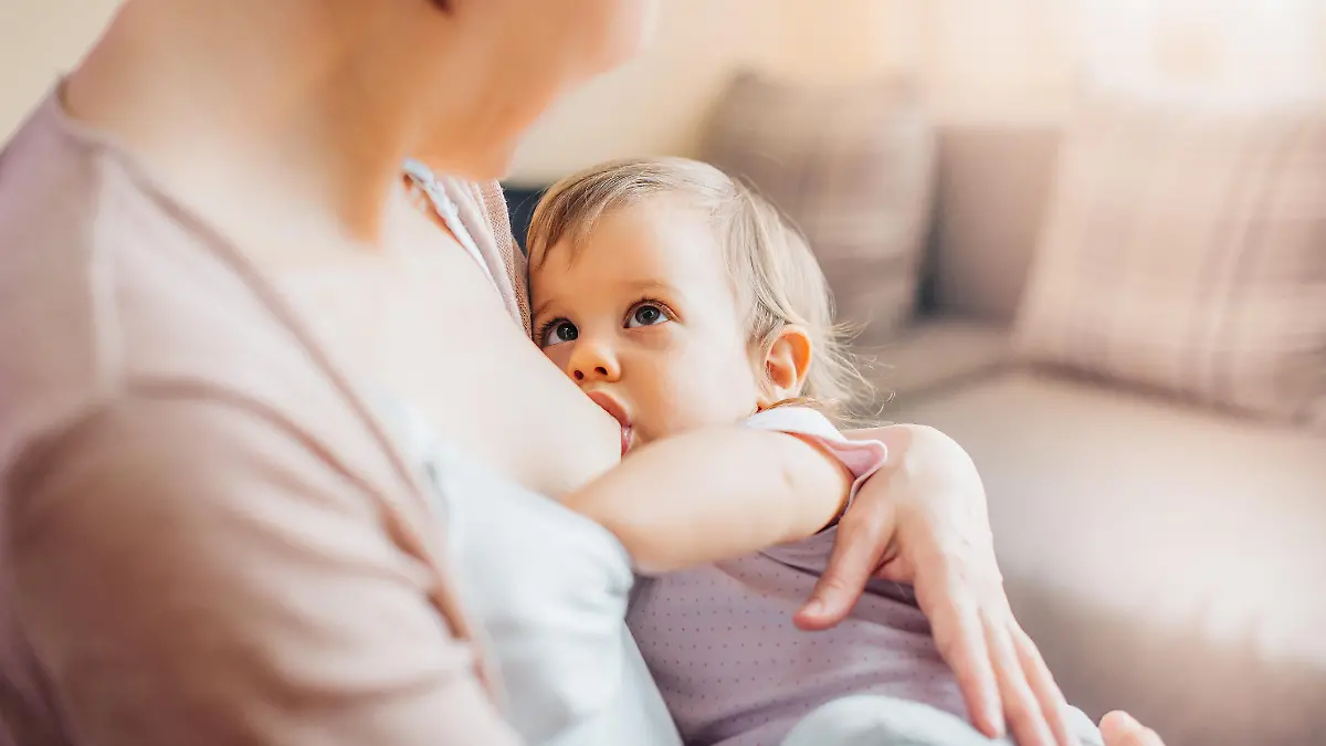 Mom nursing toddler daughter