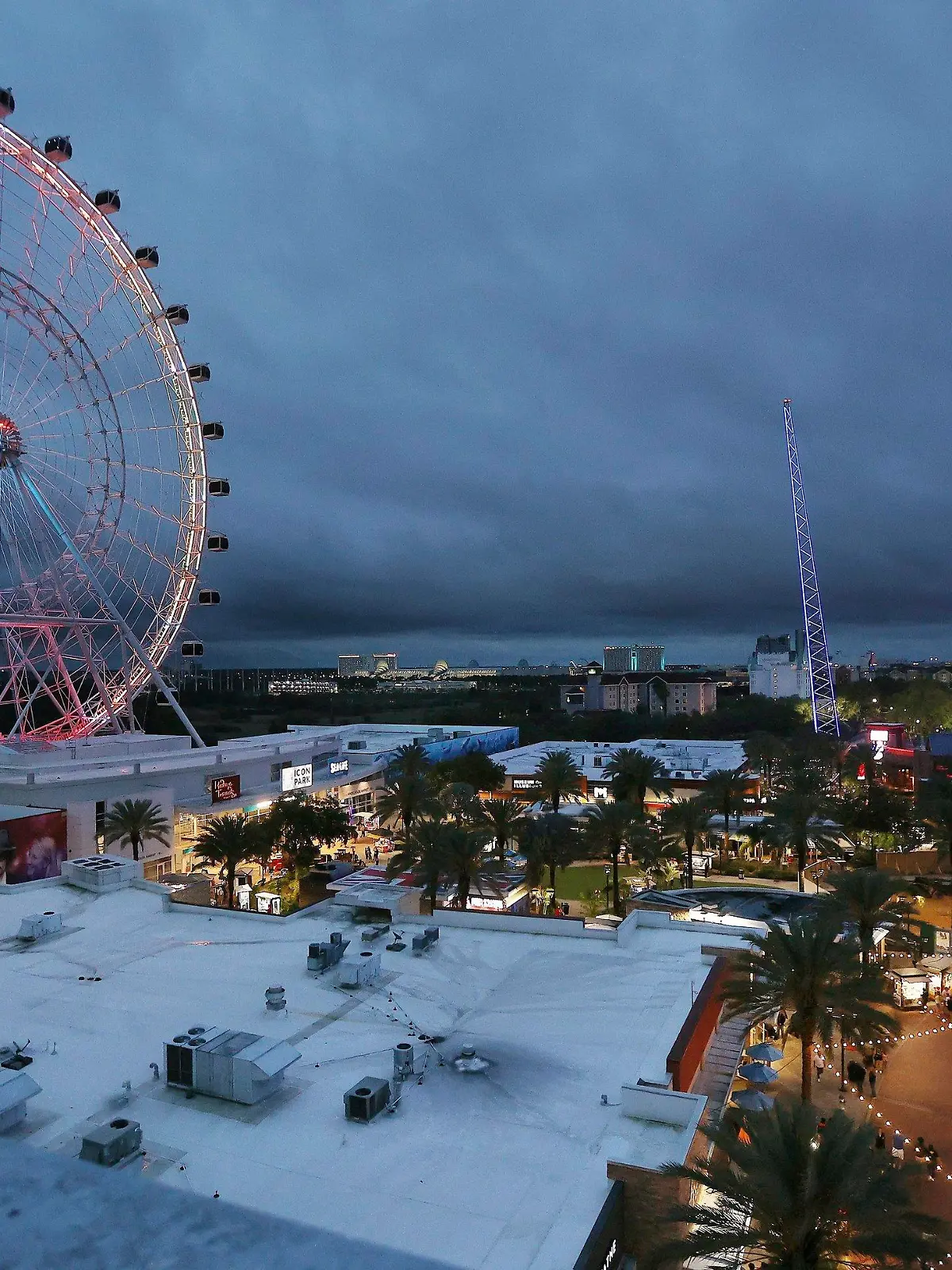 ICON Park attractions, The Wheel, left, Orlando SlingShot, middle, and Orlando FreeFall, right, are shown in Orlando, Fla., on Thursday, March 24, 2022.   A 14-year-old boy fell to his death from a ride at an amusement park in Orlando, sheriff's officials said. Sheriff's officials and emergency crews responded to a call late Thursday at Icon Park, which is located in the city's tourist district along International Drive. The boy fell from the Orlando Free Fall ride, which opened late last year.(Stephen M. Dowell /Orlando Sentinel via AP)