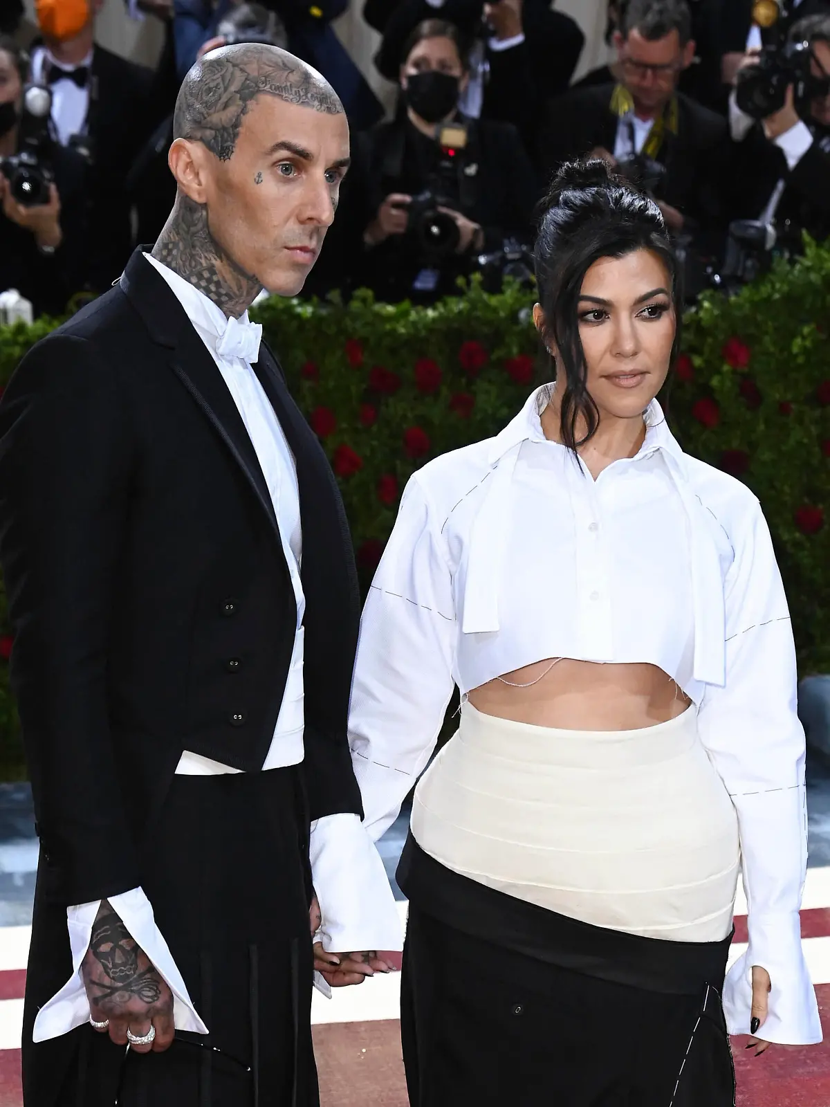 Photo by: DPRF/STAR MAX/IPx 2022 5/22/22 Kourtney Kardashian and Travis Barker wed in Italy. STAR MAX File Photo: 5/2/22 Travis Barker and Kourtney Kardashian at the 2022 Costume Institute Benefit Gala celebrating the opening of "In America: An Anthology of Fashion" held on May 2, 2022 at The Metropolitan Museum of Art in New York City.