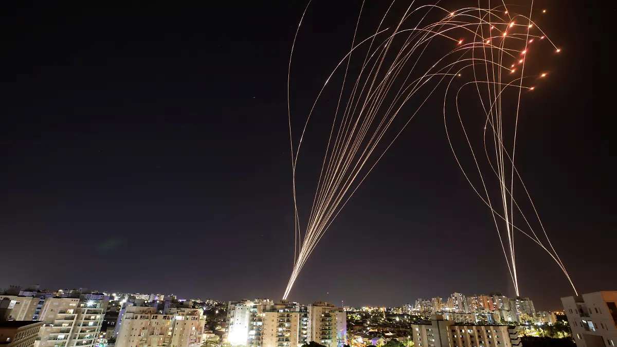 Streaks of light are seen as Israel's Iron Dome anti-missile system intercepts rockets launched from the Gaza Strip towards Israel, as seen from Ashkelon, Israel, May 11, 2021.. REUTERS/Nir Elias