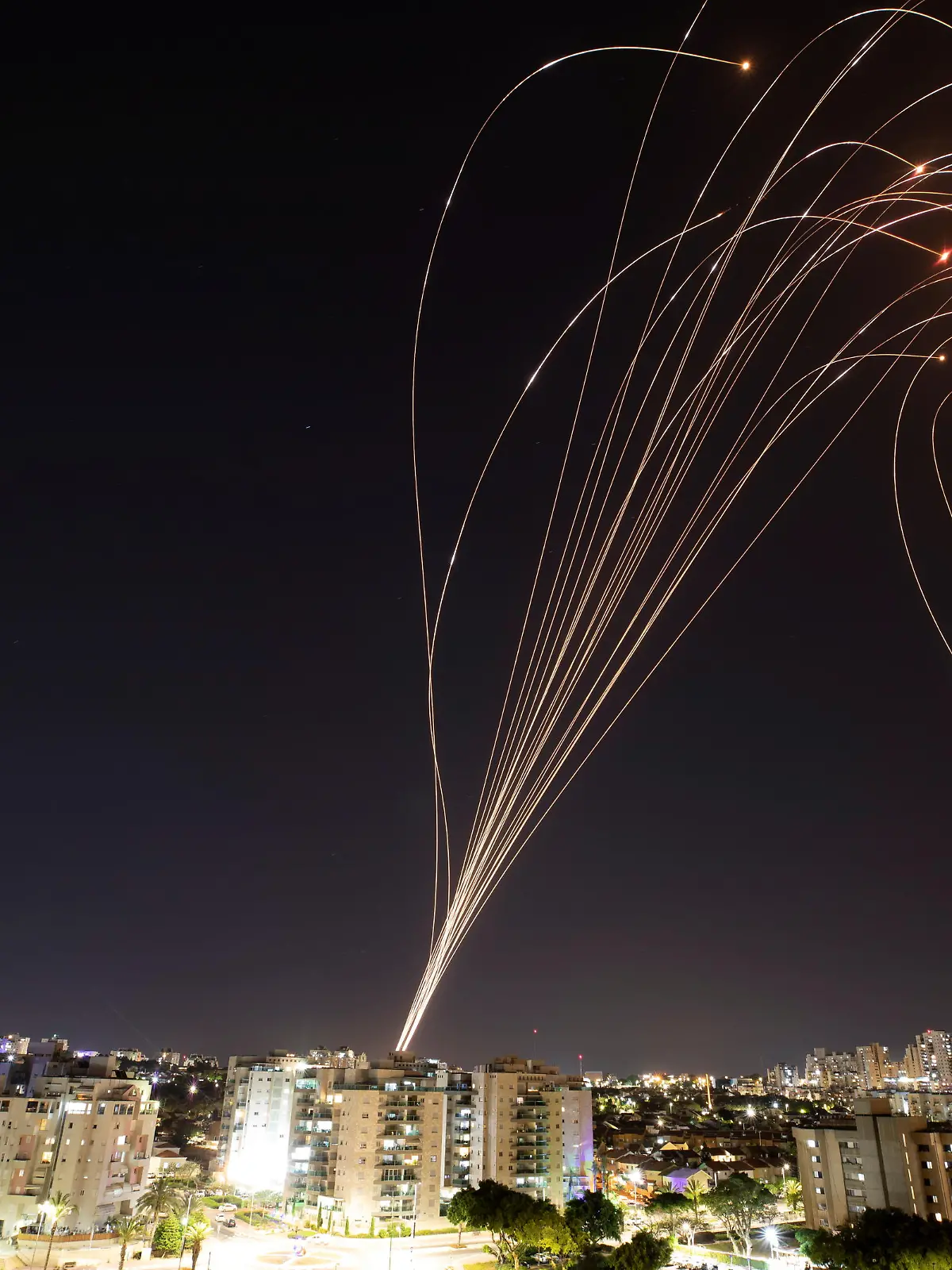 Streaks of light are seen as Israel's Iron Dome anti-missile system intercepts rockets launched from the Gaza Strip towards Israel, as seen from Ashkelon, Israel, May 11, 2021.. REUTERS/Nir Elias