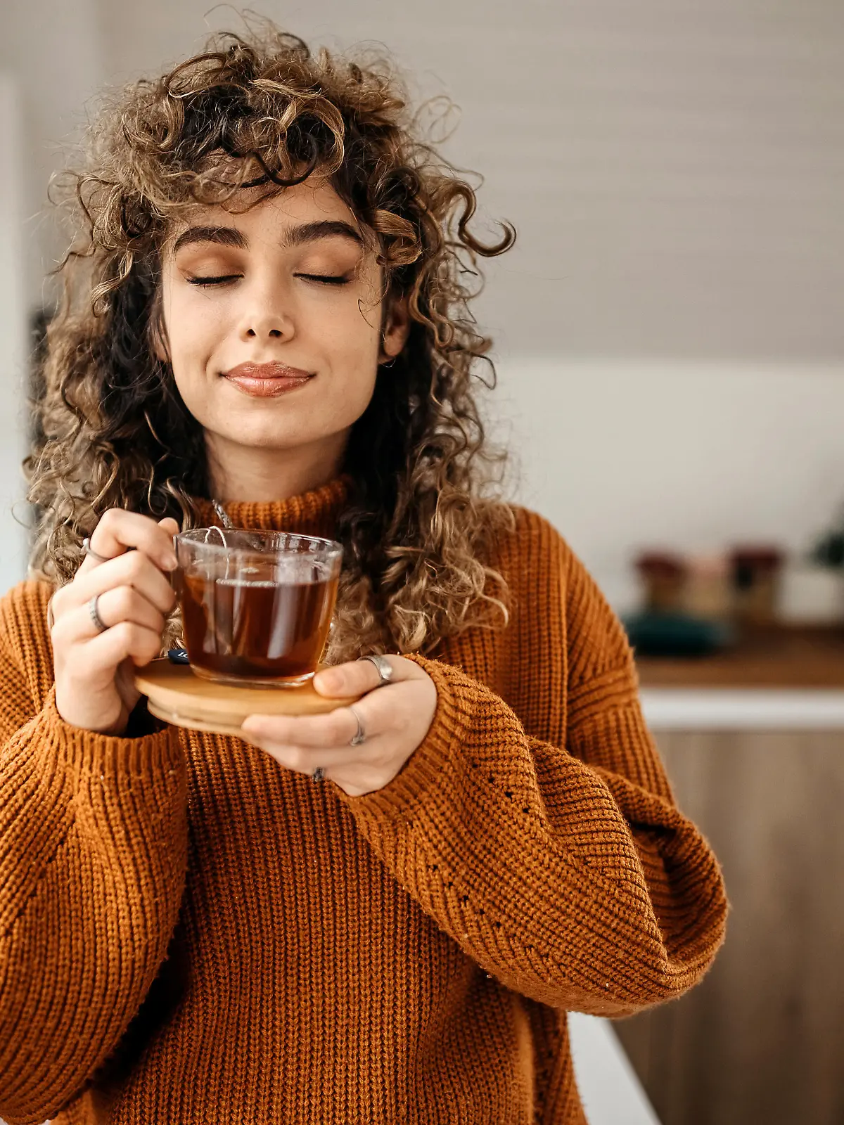 Young beautiful woman having a tea in her apartment