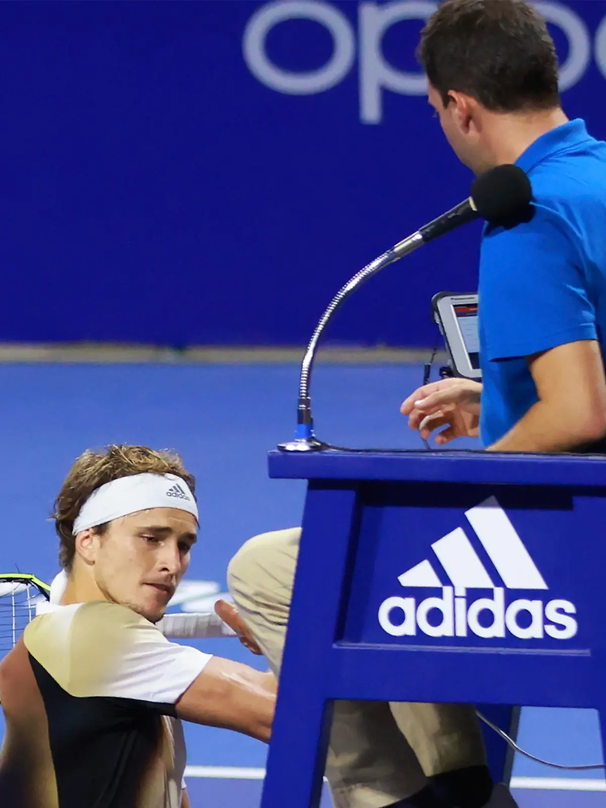 In this photo released by MexTenis, third-ranked Alexander Zverev of Germany smashes his racket on the umpire's chair moments after losing a doubles match of the Mexican Open tennis tournament in Acapulco, Mexico, Tuesday, Feb. 22, 2022. Zverev was thrown out of the Mexican Open after he struck the umpire's chair three times, sat for a moment, then got back up and yelled at umpire Alessandro Germani that he "destroyed the whole (expletive) match" and struck the chair once more with his racket as the umpire climbed down. (Marcos Dominguez/MexTenis via AP)