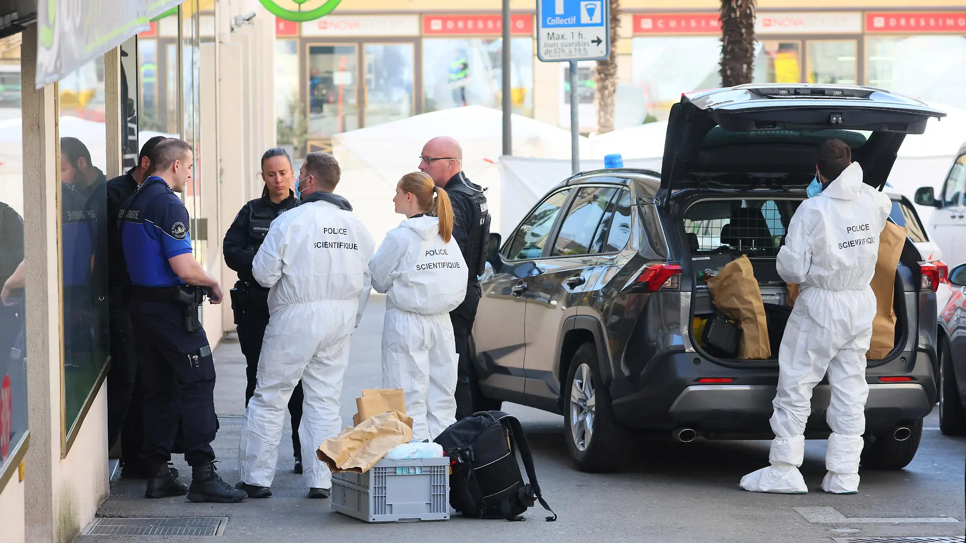 Police officers talk near the scene, after five people appeared to have jumped from an apartment in Montreux, Switzerland, March 24, 2022. REUTERS/Denis Balibouse