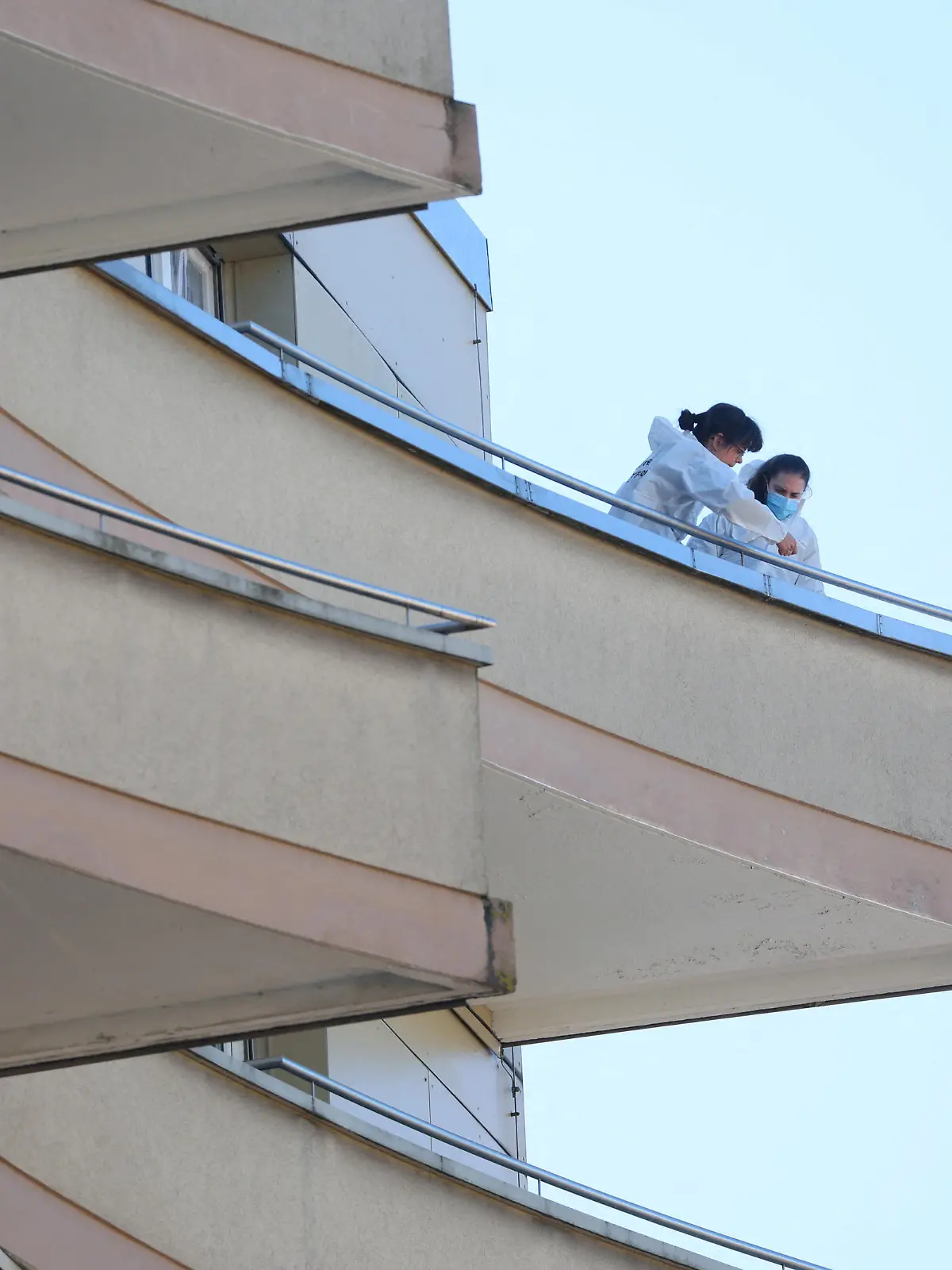 Police officers take samples on a balcony after five people appeared to have jumped from their apartment, in Montreux, Switzerland, March 24, 2022. REUTERS/Denis Balibouse