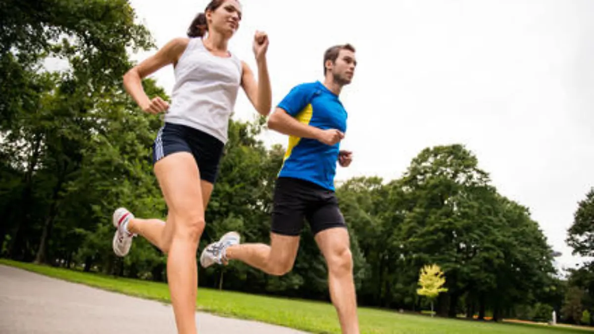 Low angle photo of young couple  jogging outdoor in park
