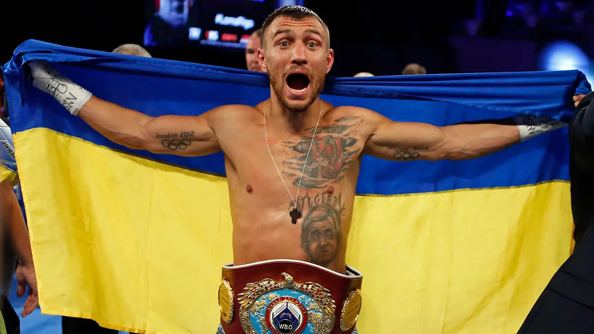 FILE - Vasiliy Lomachenko, of Ukraine, celebrates after defeating Guillermo Rigondeaux in a WBO junior lightweight title boxing match in New York, Dec. 9, 2017. Former heavyweight champions Vitali and Wladimir Klitschko are leading some of the resistance from the mayor's office in beleaguered Kyiv. Two-time Olympic champion Vasiliy Lomachenko has an assault rifle and a place in a defense force, and current heavyweight champion Aleksandr Usyk rushed back home to take up arms against the Russians. Ukraine's rich boxing community is determined to fight, this time with guns instead of their fists. (AP Photo/Adam Hunger, File)