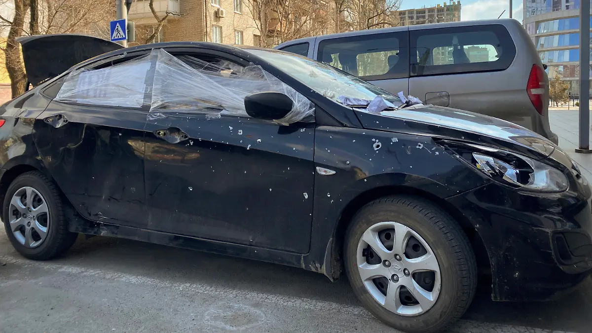 A car damaged by shelling that was used by Associated Press journalists to escape from the Mariupol blockade sits parked in Ukraine, Thursday, March 17, 2022. (AP Photo/Mstyslav Chernov)