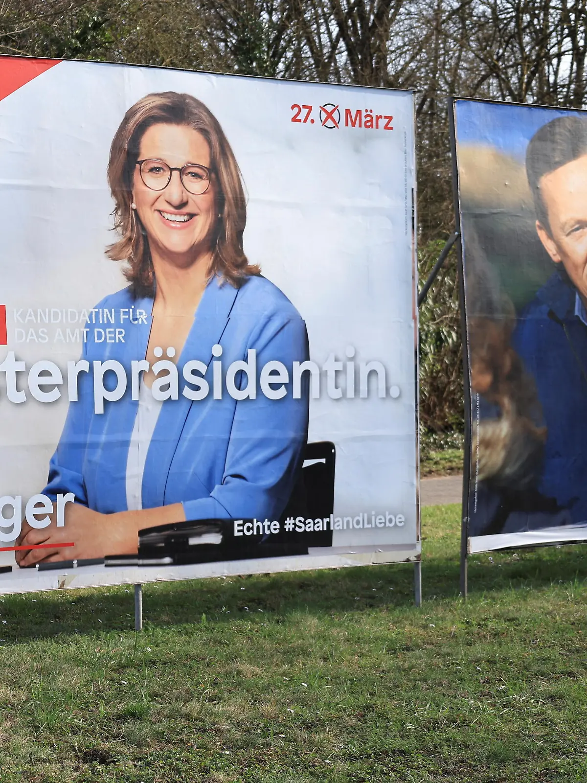 Election posters of Anke Rehlinger (L), top candidate for the Social Democratic party SPD and Tobias Hans, top candidate for the Christian Democratic Union party CDU for the upcoming March 27, 2022, election in Germany's smallest federal state of the Saarland are pictured in Voelklingen near the Saarland’s capital Saarbruecken, Germany March 21, 2022. REUTERS/Wolfgang Rattay