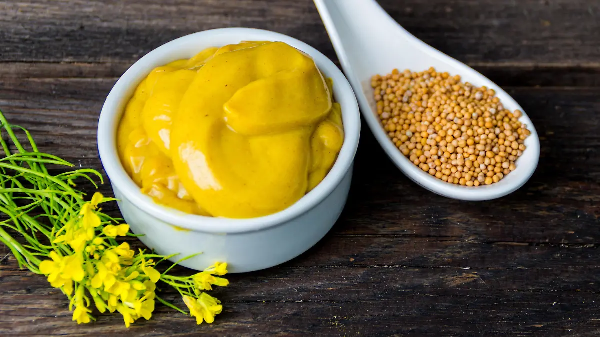 mustard sauce with its ingredients, turmeric, seeds and flowers