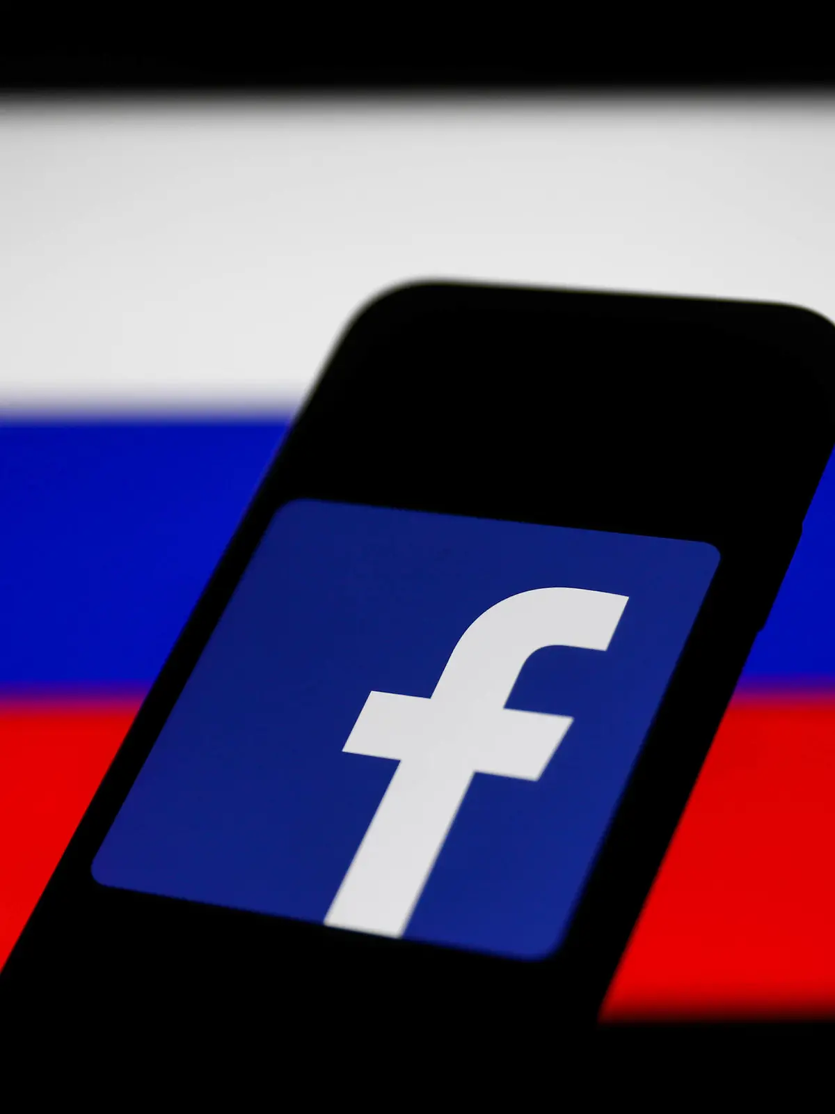  Russia And Technology Companies Photo Illustrations Facebook logo displayed on a phone screen and Russian flag displayed on a screen in the background are seen in this illustration photo taken in Krakow, Poland on March 1, 2022. Photo Illustration by Jakub Porzycki/NurPhoto Krakow Poland PUBLICATIONxNOTxINxFRA Copyright: xJakubxPorzyckix originalFilename: porzycki-russiaan220301_npbUe.jpg
