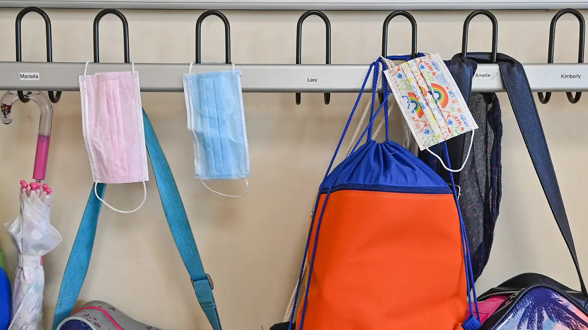 ARCHIV - 28.05.2021, Brandenburg, Frankfurt (Oder): Masken hängen zusammen mit Taschen und Rucksäcken an Kleiderhaken in einem Klassenraum einer Grundschule. Vom 7. März an entfällt die Maskenpflicht im Unterricht an den Schulen in Mecklenburg-Vorpommern. (zu dpa: «Keine Corona-Maskenpflicht im Schulunterricht mehr») Foto: Patrick Pleul/dpa-Zentralbild/ZB +++ dpa-Bildfunk +++