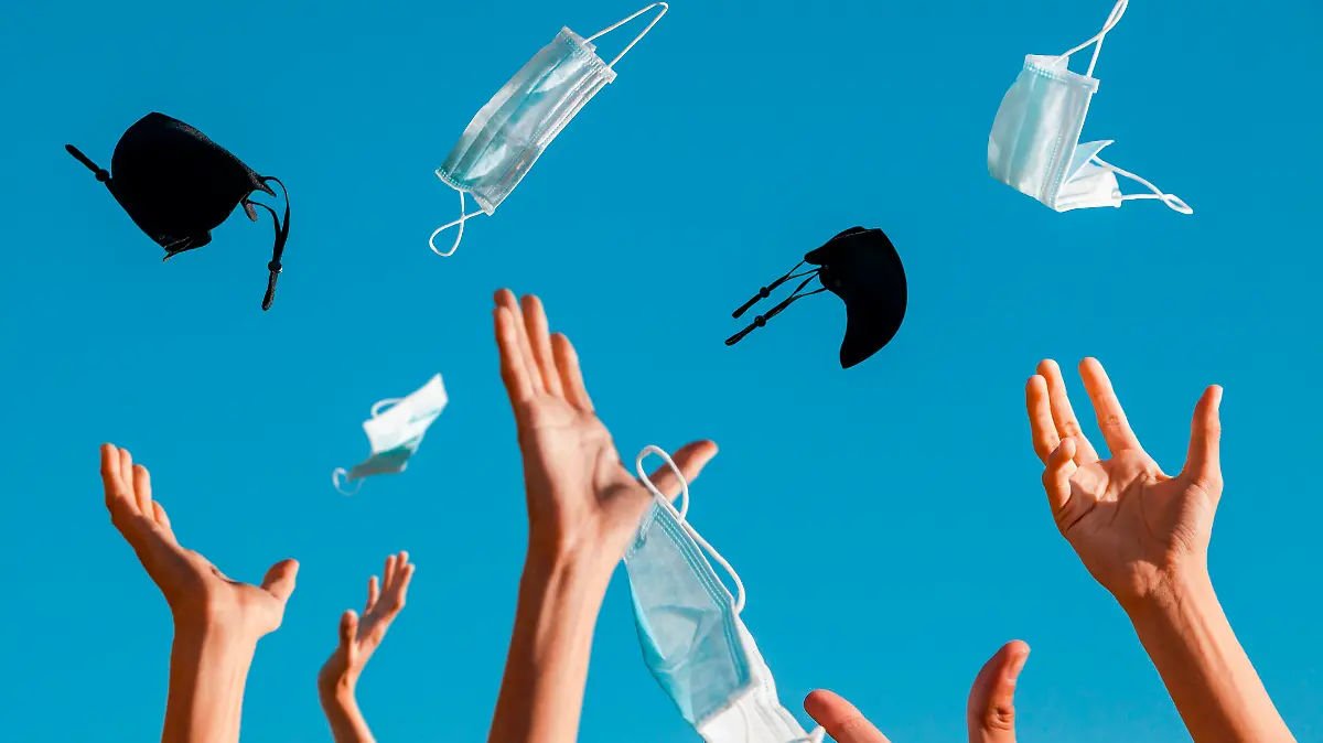 Party on the occasion of the end of the pandemic.
Hands throw protective masks in the air...