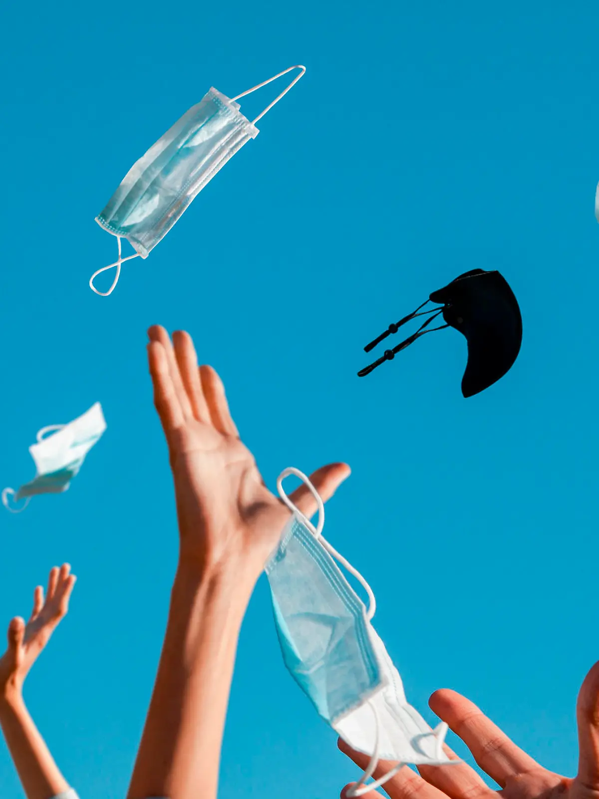 Party on the occasion of the end of the pandemic.
Hands throw protective masks in the air...