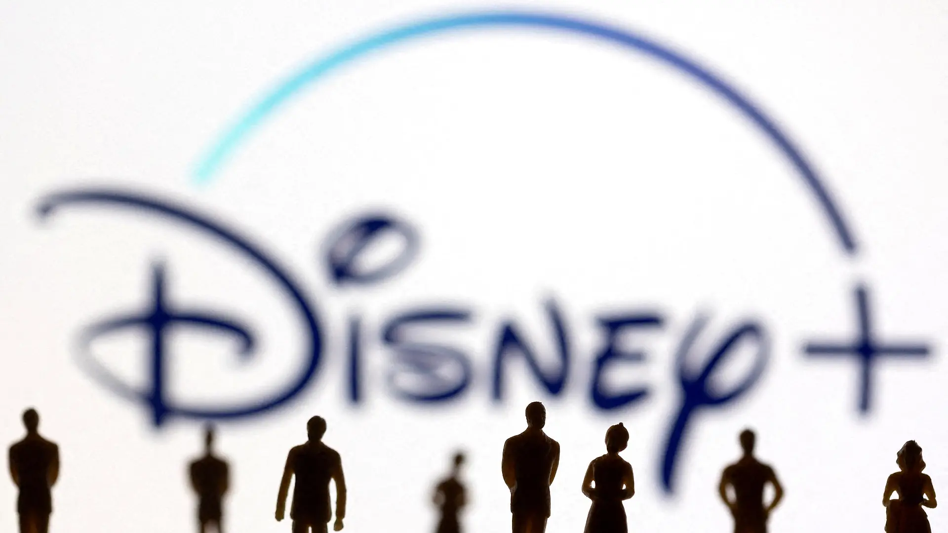 FILE PHOTO: Toy figures of people are seen in front of the displayed Disney + logo, in this illustration taken January 20, 2022. REUTERS/Dado Ruvic/Illustration/File Photo