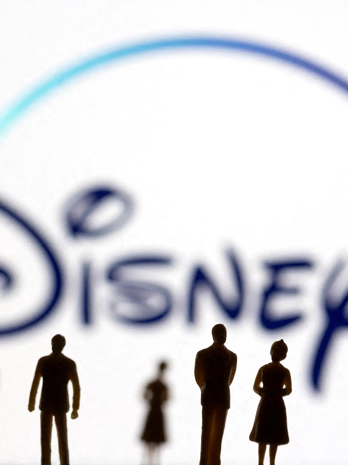FILE PHOTO: Toy figures of people are seen in front of the displayed Disney + logo, in this illustration taken January 20, 2022. REUTERS/Dado Ruvic/Illustration/File Photo