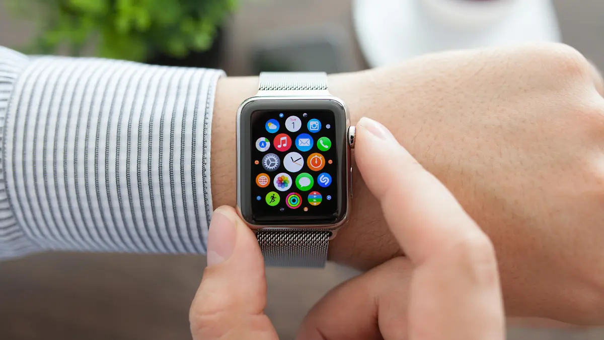 Alushta, Russia - September 1, 2015: Man hand with Apple Watch and app Icon on the screen. Apple Watch was created and developed by the Apple inc.
