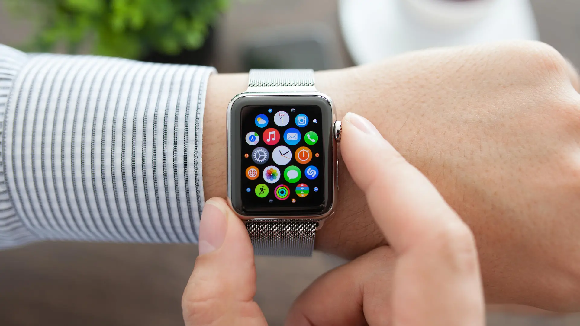 Alushta, Russia - September 1, 2015: Man hand with Apple Watch and app Icon on the screen. Apple Watch was created and developed by the Apple inc.