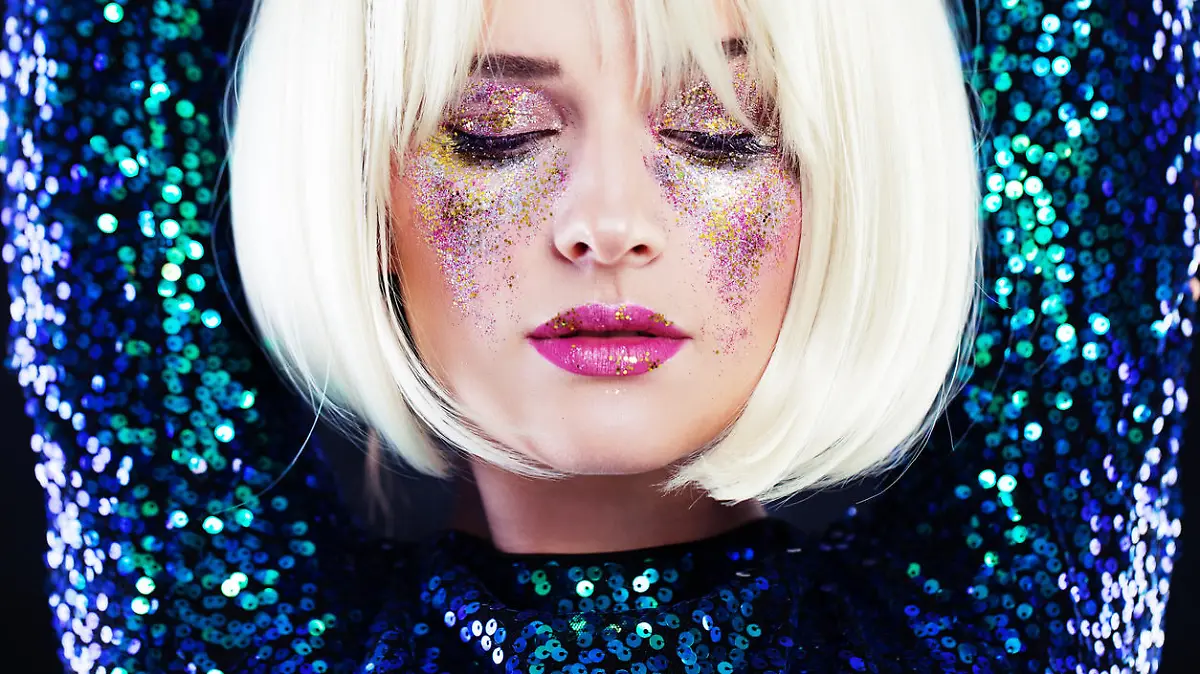 Beautiful Blonde Woman with Party Glitters Makeup