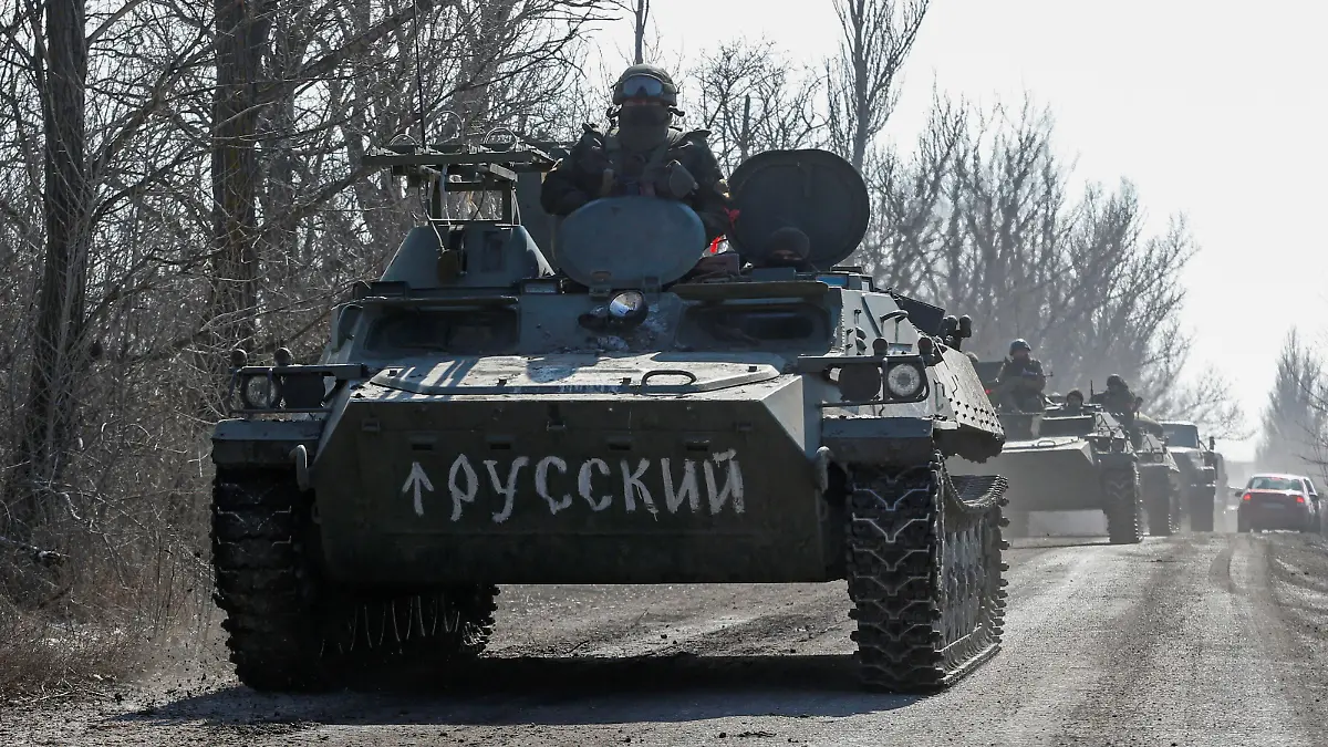 A view shows an armoured convoy of pro-Russian troops during Ukraine-Russia conflict outside the separatist-controlled town of Volnovakha in the Donetsk region, Ukraine March 12, 2022. A sign on an armoured vehicle reads: "Russian". REUTERS/Alexander Ermochenko