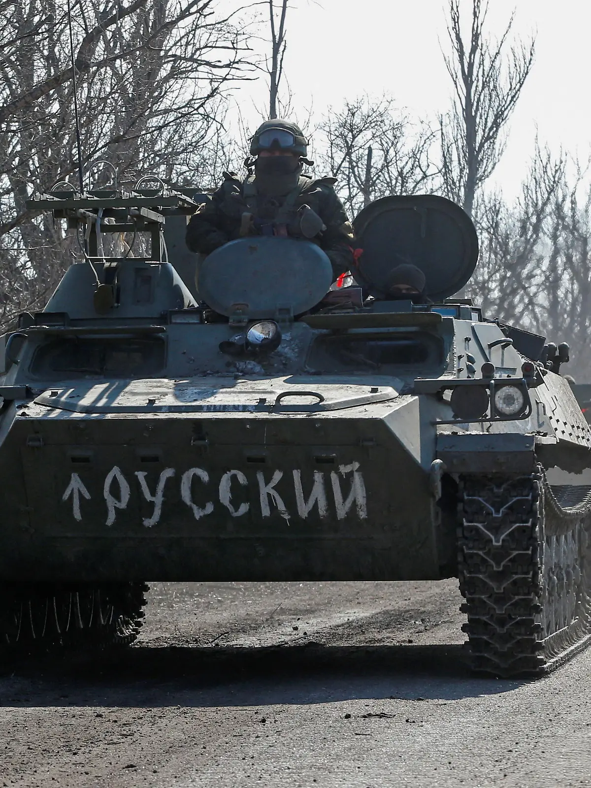 A view shows an armoured convoy of pro-Russian troops during Ukraine-Russia conflict outside the separatist-controlled town of Volnovakha in the Donetsk region, Ukraine March 12, 2022. A sign on an armoured vehicle reads: "Russian". REUTERS/Alexander Ermochenko