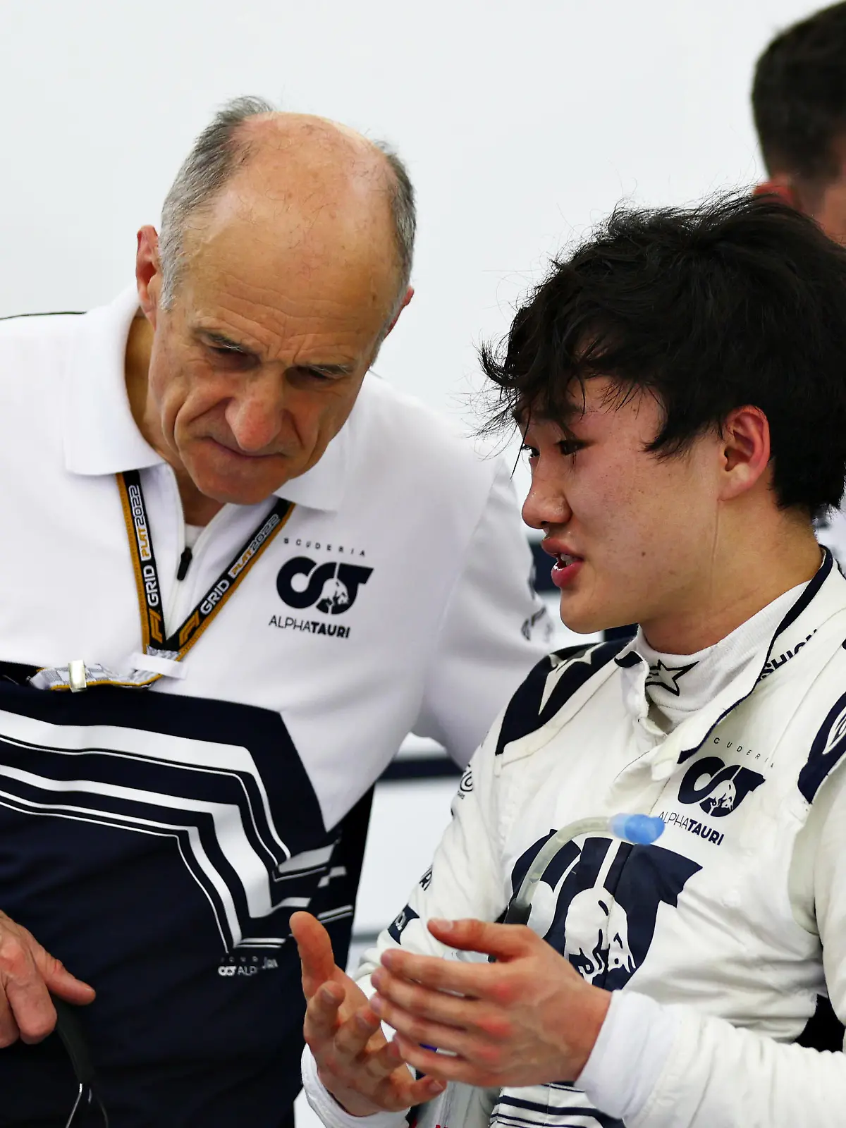 BAHRAIN, BAHRAIN - MARCH 11: Yuki Tsunoda of Japan and Scuderia AlphaTauri talks to Scuderia AlphaTauri Team Principal Franz Tost in the garage during Day Two of F1 Testing at Bahrain International Circuit on March 11, 2022 in Bahrain, Bahrain. (Photo by Lars Baron/Getty Images)