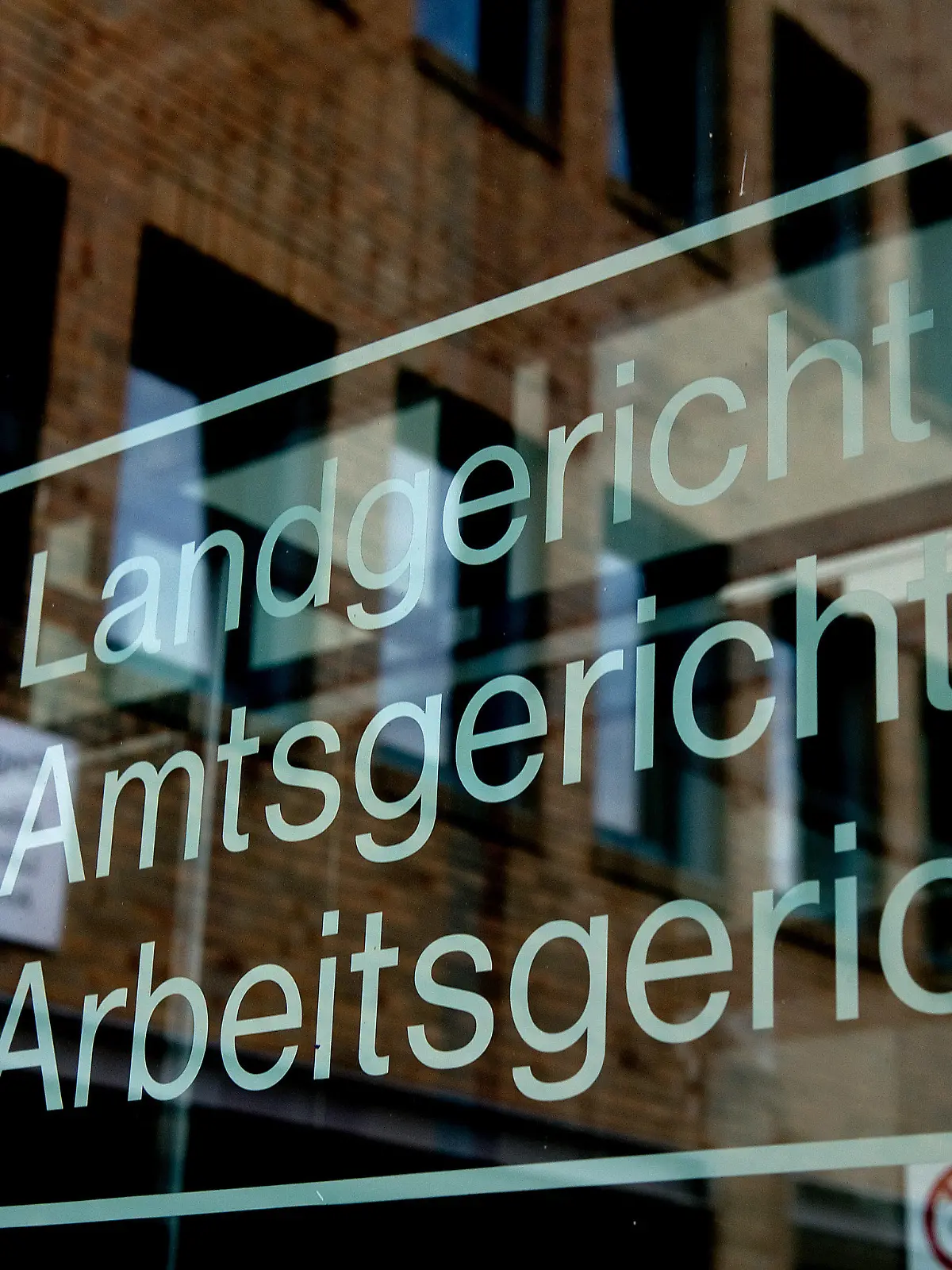 ARCHIV - Der Schriftzug «Landgericht, Amtsgericht, Arbeitsgericht» ist am 06.08.2013 am Haupteingang im Landgericht in Göttingen (Niedersachsen) mit einer Spiegelung des Gerichtsgebäudes zu sehen. Wegen eines Mordes an einer Kommilitonin steht eine Studentin vom 26.04.2016 in Göttingen vor Gericht. Foto: Swen Pförtner/dpa (zu dpa "Prozess um Eifersuchts-Mord in Göttingen beginnt" vom 26.04.2016) +++(c) dpa - Bildfunk+++