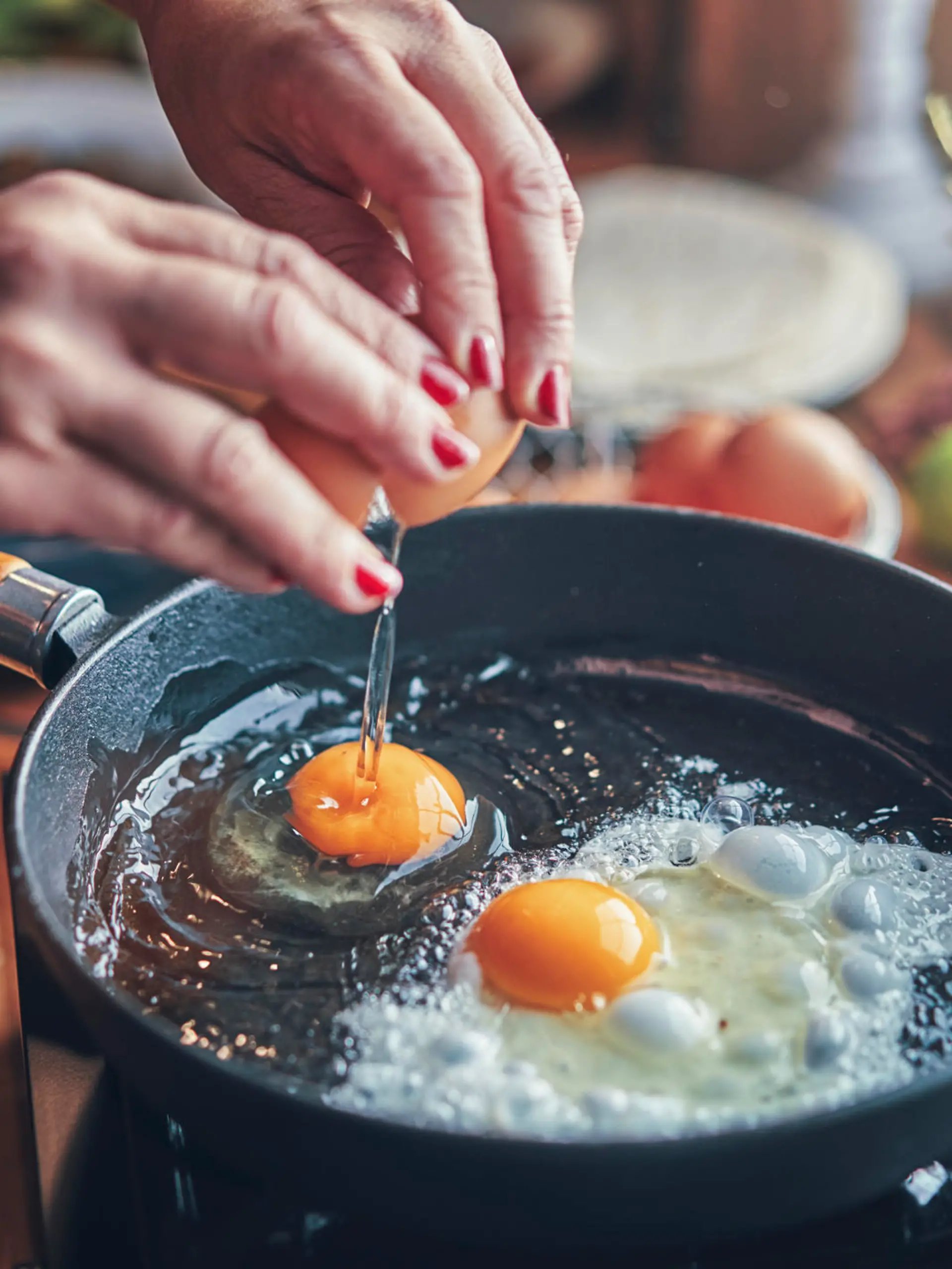                                 Frying Egg in a Cooking Pan in Domestic Kitchen